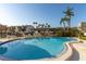 Community pool with plenty of seating and palm trees for shade at 1581 Gulf Blvd # 301N, Clearwater Beach, FL 33767