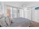 Bright bedroom features a queen bed, ceiling fan, and access to a balcony with nice water views at 16400 Gulf Blvd # 505, North Redington Beach, FL 33708