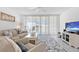 Open-concept living area with comfortable seating and access to a balcony at 16400 Gulf Blvd # 505, North Redington Beach, FL 33708