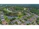 Aerial view showcases a home in a community near a golf course and scenic pond at 18836 Maisons Dr, Lutz, FL 33558