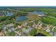 Aerial view of neighborhood featuring waterfront homes, mature trees, and convenient access to nearby highways at 18836 Maisons Dr, Lutz, FL 33558