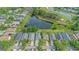 Aerial view of the home in a beautiful neighborhood with lush landscaping and a picturesque pond and golf course nearby at 18836 Maisons Dr, Lutz, FL 33558