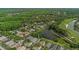 Aerial view of a lovely home, bordering a serene pond and golf course in a residential community at 18836 Maisons Dr, Lutz, FL 33558