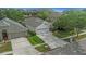 This home features a patterned driveway, a two-car garage, and is surrounded by lush landscaping, enhancing its curb appeal at 18836 Maisons Dr, Lutz, FL 33558