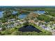 Aerial view of a residential community featuring homes with water views and mature landscaping at 18836 Maisons Dr, Lutz, FL 33558