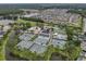Aerial view of community showcasing amenities like tennis courts, a pool, and lush landscaping at 18836 Maisons Dr, Lutz, FL 33558