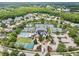 Aerial view of a community clubhouse, tennis courts, basketball courts, pool, and parking at 18836 Maisons Dr, Lutz, FL 33558