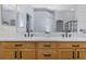 Bathroom with double sink vanity, quartz countertop, and modern black fixtures at 18836 Maisons Dr, Lutz, FL 33558
