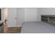 A cozy bedroom featuring wood-look floors, a closet, and a headboard with built-in shelves at 18836 Maisons Dr, Lutz, FL 33558