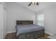 Bedroom featuring a gray bed with storage, wood flooring, and a ceiling fan at 18836 Maisons Dr, Lutz, FL 33558