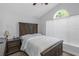 Bedroom with wood accents, headboard storage, natural light and decorative arched window at 18836 Maisons Dr, Lutz, FL 33558
