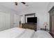 Bedroom featuring a vaulted ceiling, wooden dresser, and bed, with doorway to ensuite bath at 18836 Maisons Dr, Lutz, FL 33558