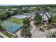 Aerial view of the community center featuring a pool, tennis courts, and a basketball court at 18836 Maisons Dr, Lutz, FL 33558