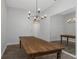 Dining area featuring a wooden table, decorative chandelier, hardwood floors, and mirror at 18836 Maisons Dr, Lutz, FL 33558