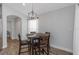 Cozy dining area with a modern chandelier and seating for four, ideal for intimate meals at 18836 Maisons Dr, Lutz, FL 33558