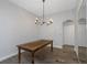 Rustic dining area featuring a wooden table, decorative chandelier, and hardwood floors at 18836 Maisons Dr, Lutz, FL 33558