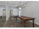 Spacious dining area with a large wooden table, chandelier, and wood-look flooring, perfect for gatherings at 18836 Maisons Dr, Lutz, FL 33558