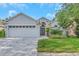 Charming single-story home featuring manicured landscaping and a spacious two-car garage, enhancing its curb appeal at 18836 Maisons Dr, Lutz, FL 33558