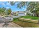 Charming single-story home with a well-manicured lawn and a paved driveway leading to an attached two-car garage at 18836 Maisons Dr, Lutz, FL 33558