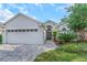 Charming single-story home featuring manicured landscaping and a spacious two-car garage, enhancing its curb appeal at 18836 Maisons Dr, Lutz, FL 33558
