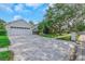 Attractive home boasting a well-maintained front lawn, a patterned driveway, and a two-car garage for ample parking at 18836 Maisons Dr, Lutz, FL 33558