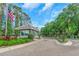 Entrance to a gated community with an American flag flying and a guard house at 18836 Maisons Dr, Lutz, FL 33558