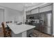 Spacious kitchen with gray cabinetry, stainless steel appliances, and a large center island at 18836 Maisons Dr, Lutz, FL 33558