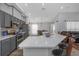 Modern kitchen with gray cabinets, a white countertop island, and stainless steel appliances at 18836 Maisons Dr, Lutz, FL 33558