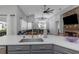Open floor plan showing the kitchen with island, stainless sink and spacious living room at 18836 Maisons Dr, Lutz, FL 33558