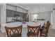 Bright kitchen with gray cabinets, a central island, and stainless steel appliances at 18836 Maisons Dr, Lutz, FL 33558