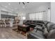 Spacious living room featuring a modern kitchen, and a comfortable seating area with a large sectional sofa at 18836 Maisons Dr, Lutz, FL 33558