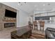 Open-concept living room with a stone fireplace and a kitchen featuring bar seating for seamless entertaining at 18836 Maisons Dr, Lutz, FL 33558