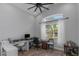 Bright home office featuring a vaulted ceiling, lots of sunlight, and backyard views at 18836 Maisons Dr, Lutz, FL 33558