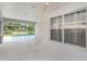 A screened patio with access to a pool and a view of the surrounding area at 18836 Maisons Dr, Lutz, FL 33558