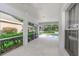 A screened patio with a view of the pool and landscaping at 18836 Maisons Dr, Lutz, FL 33558