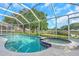 A large screened pool features a jacuzzi and seating area at 18836 Maisons Dr, Lutz, FL 33558