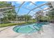 A pool is enclosed in a screen and features a jacuzzi at 18836 Maisons Dr, Lutz, FL 33558