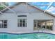 A screened pool features steps into the pool and is attached to the back of the house at 18836 Maisons Dr, Lutz, FL 33558