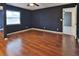 Bedroom featuring a view to the hallway and wood flooring at 1915 Peppertree Dr, Oldsmar, FL 34677