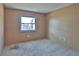 Bedroom with a window providing natural light and neutral carpeting at 1915 Peppertree Dr, Oldsmar, FL 34677