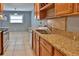 Kitchen featuring stainless steel appliances, granite countertops, tile flooring and ample cabinet space at 1915 Peppertree Dr, Oldsmar, FL 34677