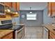 Eat-in kitchen area offering tiled flooring and great natural light, complemented by stainless steel appliances at 1915 Peppertree Dr, Oldsmar, FL 34677