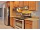 Well-equipped kitchen with stainless steel appliances, granite countertops, and light wood cabinets for ample storage at 1915 Peppertree Dr, Oldsmar, FL 34677
