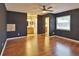 Main bedroom with wood flooring, ceiling fan, and attached bath at 1915 Peppertree Dr, Oldsmar, FL 34677