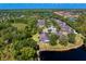 Aerial view of a community with lush trees, ponds, and houses with screened lanais at 19194 Lake Audubon Dr, Tampa, FL 33647