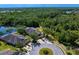 Aerial view of a home on a cul-de-sac with mature trees and a pond at 19194 Lake Audubon Dr, Tampa, FL 33647
