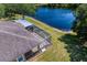 Aerial view of the back of the house showcasing a screened lanai near a pond at 19194 Lake Audubon Dr, Tampa, FL 33647