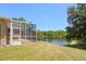 Beautiful view of a pond from the backyard with a screened lanai at 19194 Lake Audubon Dr, Tampa, FL 33647