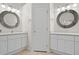 Well-lit bathroom featuring double sinks, large mirrors, and ample counter space, perfect for daily routines at 19194 Lake Audubon Dr, Tampa, FL 33647