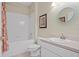 Bright bathroom features tiled shower-tub combination and modern white vanity at 19194 Lake Audubon Dr, Tampa, FL 33647